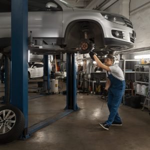 male-mechanic-working-shop-car